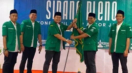 H Abdul Kharis Ma'mun menyerahkan bendera Ansor kepada H Habibi